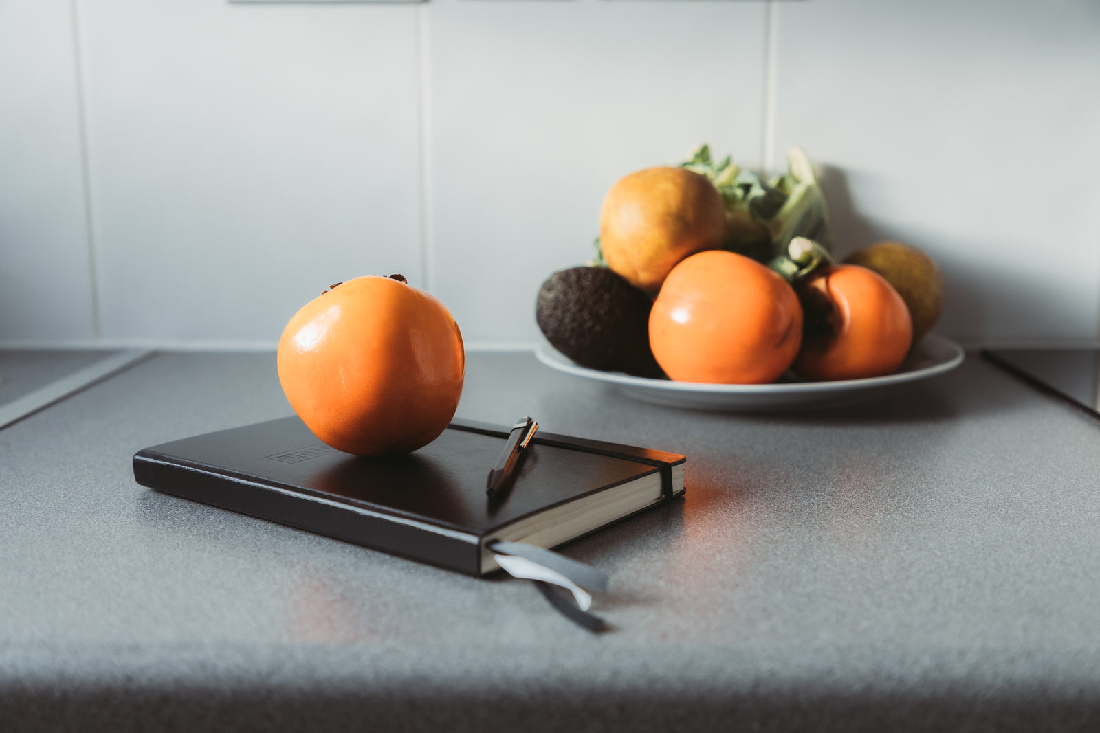 A notebook and pen on a calm surface
